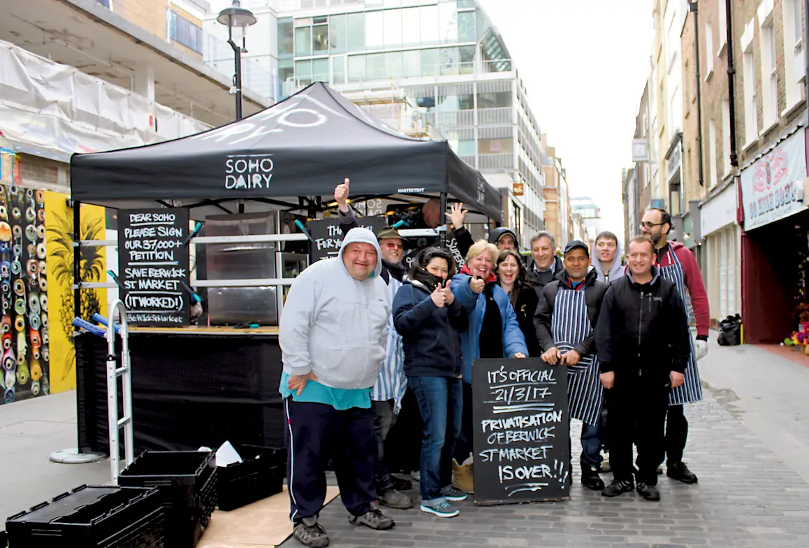 Berwick Street Market traders pose for a picture at the Soho Dairy stall