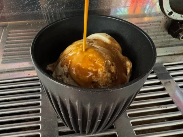 An image of rich espresso being poured over Soho Dairy raw honey ice cream for an affogato