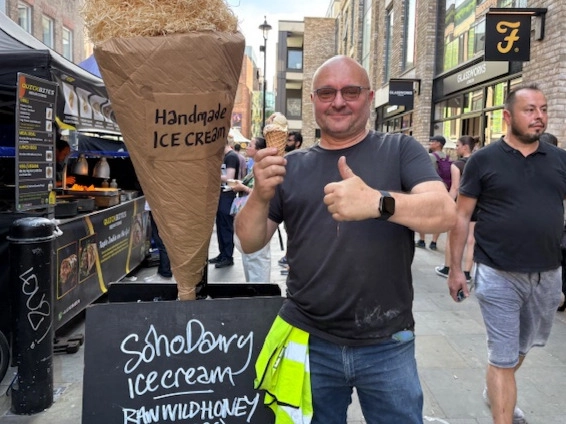 An image showing a man at the Soho Dairy stall eating a Soho Dairy ice cream and giving a thumbs up