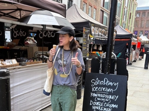 An image showing a woman at the Soho Dairy stall eating a Soho Dairy ice cream and giving a thumbs up
